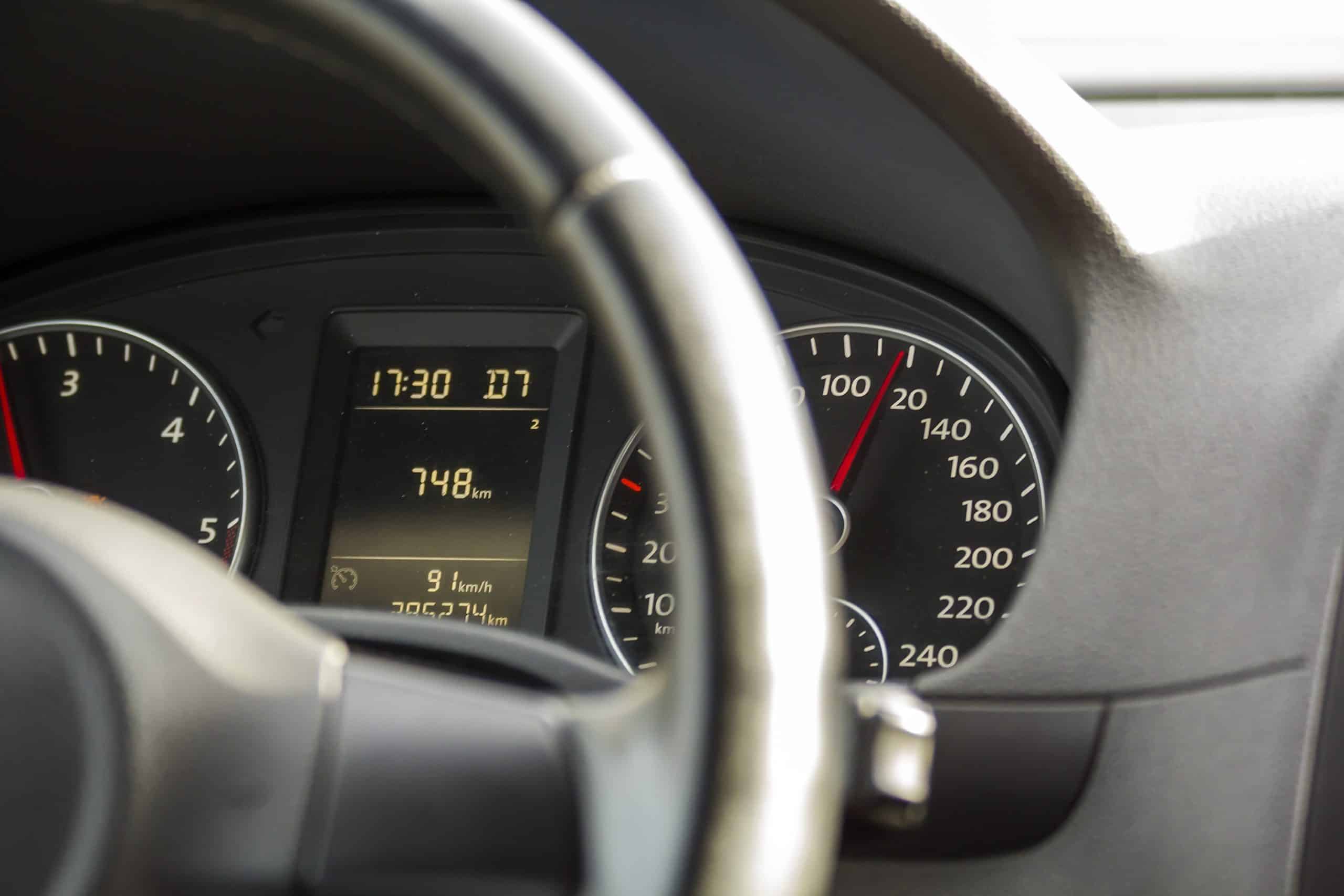 close up interior view of modern luxurious black car. dashboard, steering wheel, speedometer. speed, comfort and luxury.