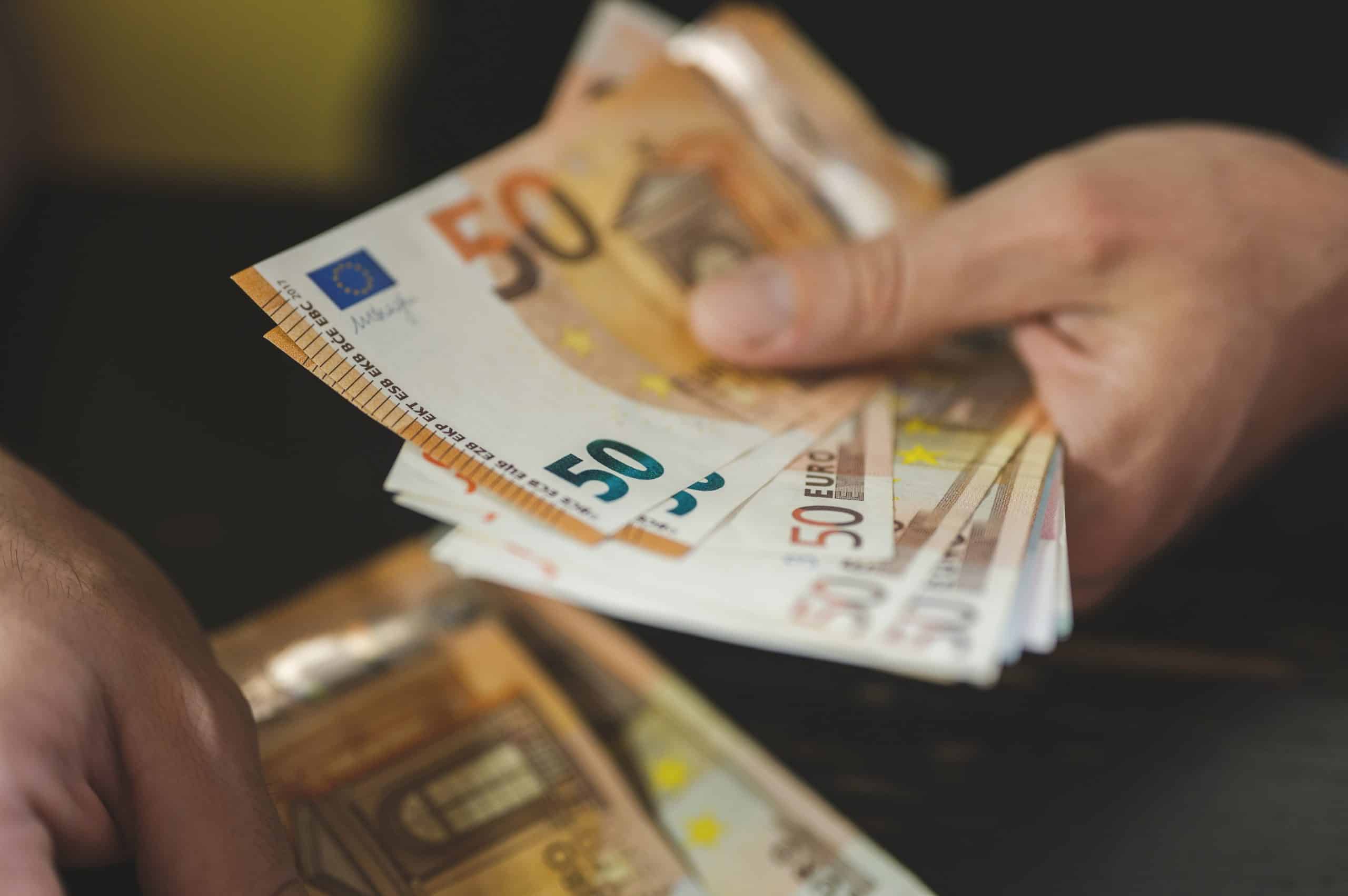 business man counting money. rich male hands holds and count cash banknotes of 50 euros bills or notes currency