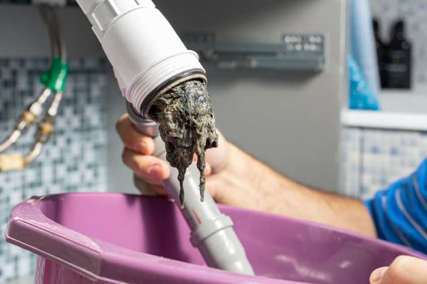 the plumber removes the blockage in the pipes
